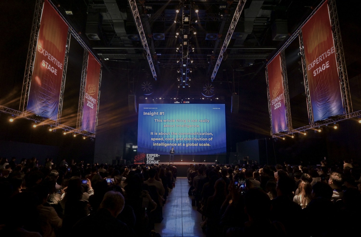 Large workshop stage with audience and presentation screen